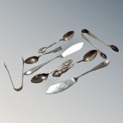 A collection of eight continental and English silver teaspoons, sugar tongs and fish knives.