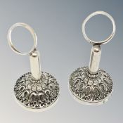 A pair of ornate silver napkin holders,