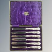 A set of 6 silver-handled butter knives.