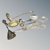 A group of silver and other items including caddy spoon, strainer, salt,
