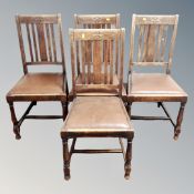 A set of four Edwardian oak rail backed dining chairs