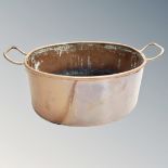 A 19th century twin handled copper cooking pot