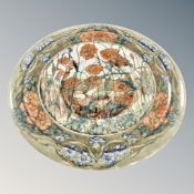 A circular ceramic wall plaque decorated with poppies, width 38.5cm.