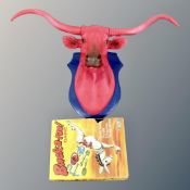 A box containing vintage Ideal games Buck-a-roo together with a contemporary cow's head bust