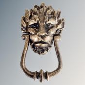 A cast iron lion's head door knocker.