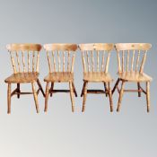 A set of four pine spindle backed kitchen chairs