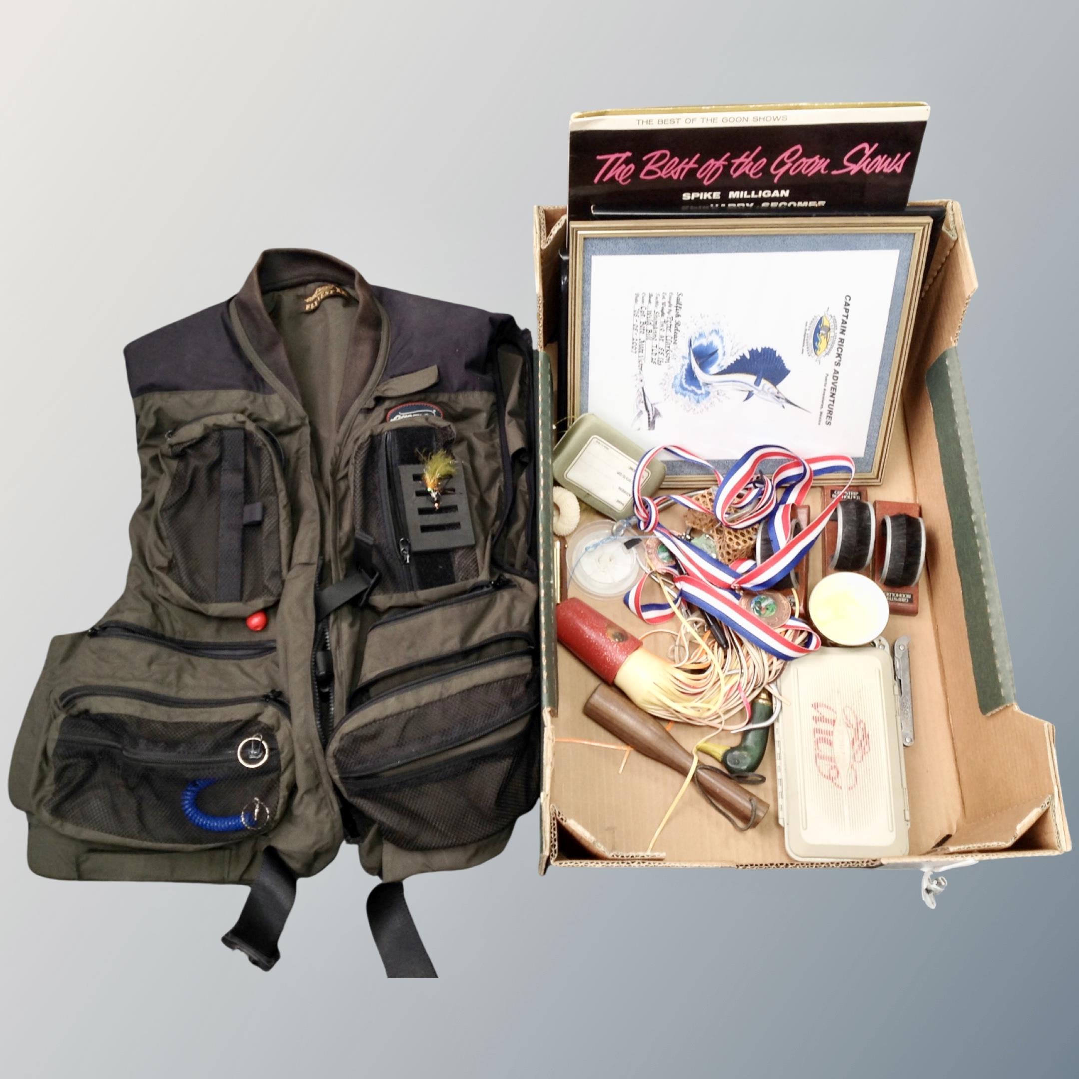 A box containing a airflo fly vest size XXL together with a box containing fishing related items.