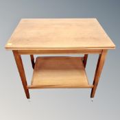 A 20th century teak two tier turn over top card table / trolley