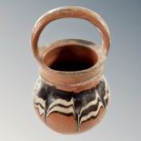 An antique glazed pot with handle,