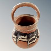 An antique glazed pot with handle,