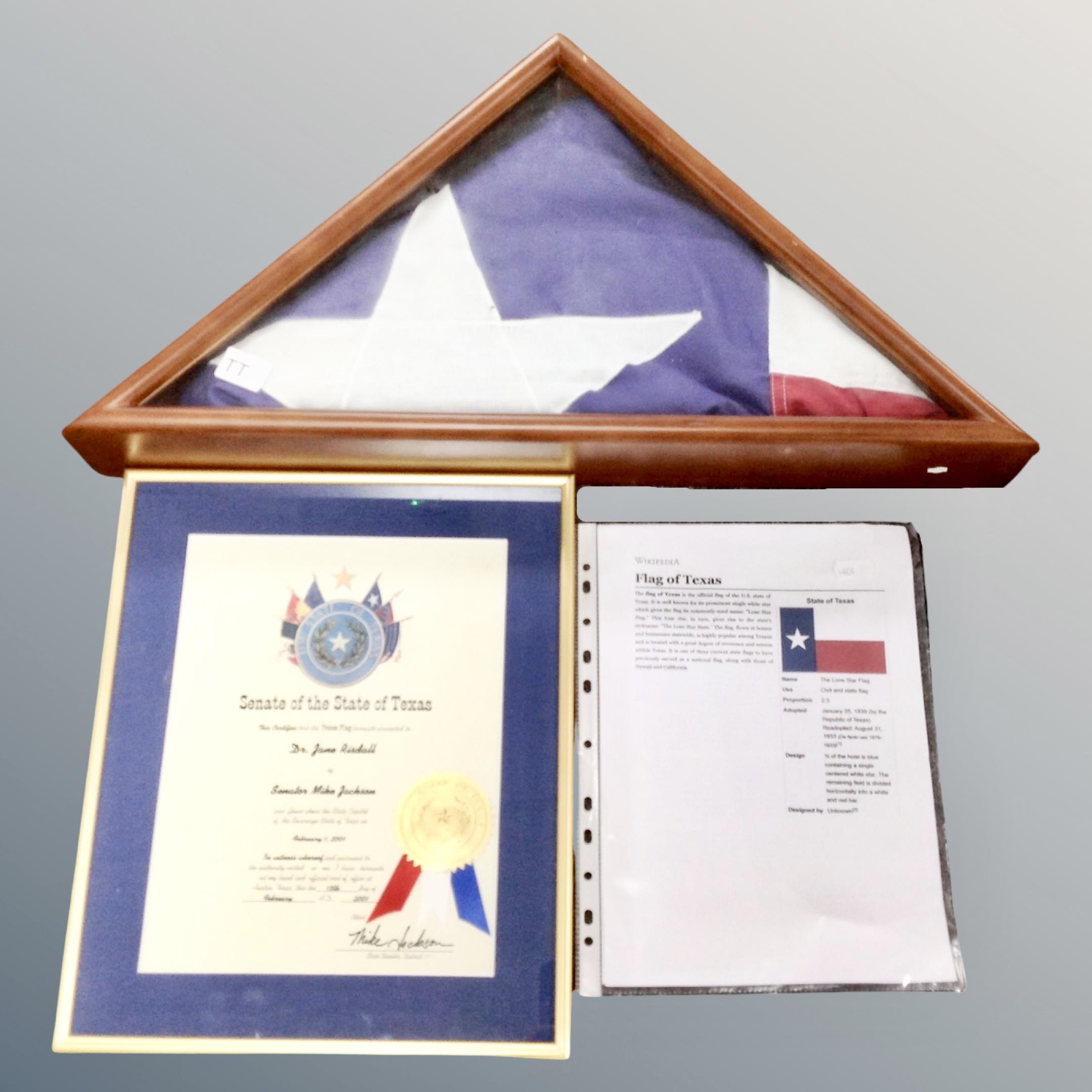 A folded Texas flag in triangular display frame which was presented to Dr.