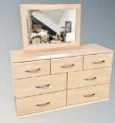 A contemporary seven drawer dressing chest with mirror back
