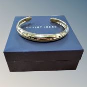 An Ernest Jones silver-gilt bangle, boxed. CONDITION REPORT: 14.