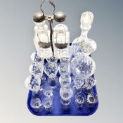 A tray containing assorted etched and cut glass drinking glasses, decanters,