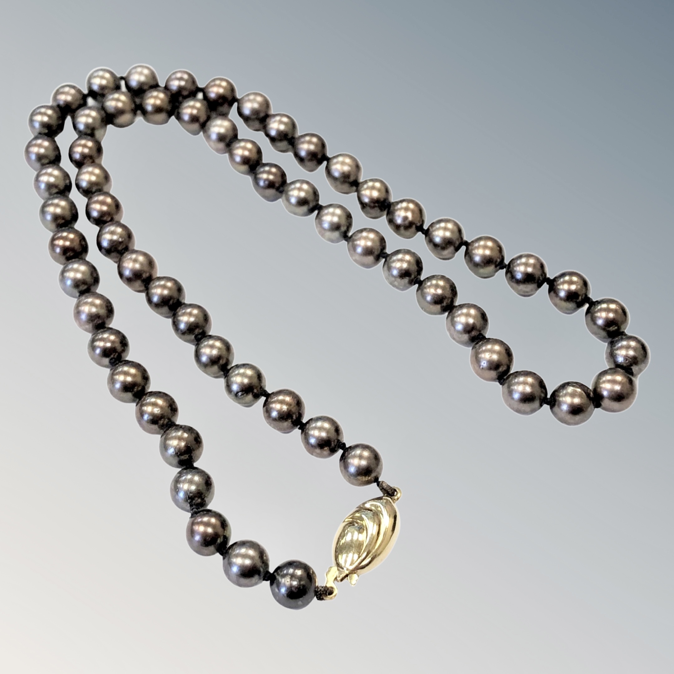 A strap of pearls on 18ct gold clasp