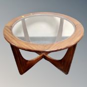A circular teak glass topped coffee table
