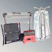 A folding ironing board together with two folding clothes airers and a two tread hailo folding