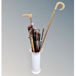 A ceramic stick stand containing walking sticks, canes,