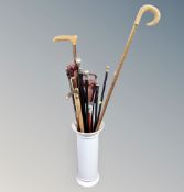 A ceramic stick stand containing walking sticks, canes,