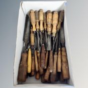 A box of vintage woodworking chisels