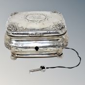A 19th century German silver tea caddy, coat of arms to lid, on ball feet, original silver key.