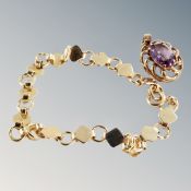 A gilt bracelet together with a gilt pendant with synthetic amethyst.