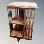 A mahogany three tier revolving book table