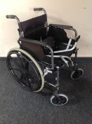 A folding lightweight wheelchair CONDITION REPORT: with footrests - brought in late