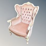 A French baroque style wingback armchair in pink dralon