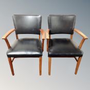 A pair of 20th century beech framed black vinyl armchairs