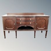 A Victorian mahogany double door serpentine fronted sideboard fitted with two drawers on raised