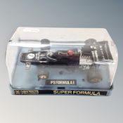 A 20th century Scalextric John Player Special Formula 1 car in plastic display box.