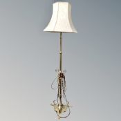 A brass and copper Art Nouveau standard lamp with shade