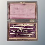 A set of antique drawing instruments in a fitted box