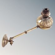 A Victorian brass oil lamp on bracket.