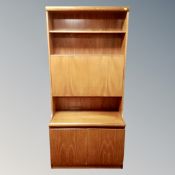 A mid century teak bureau bookcase with double door cupboards beneath