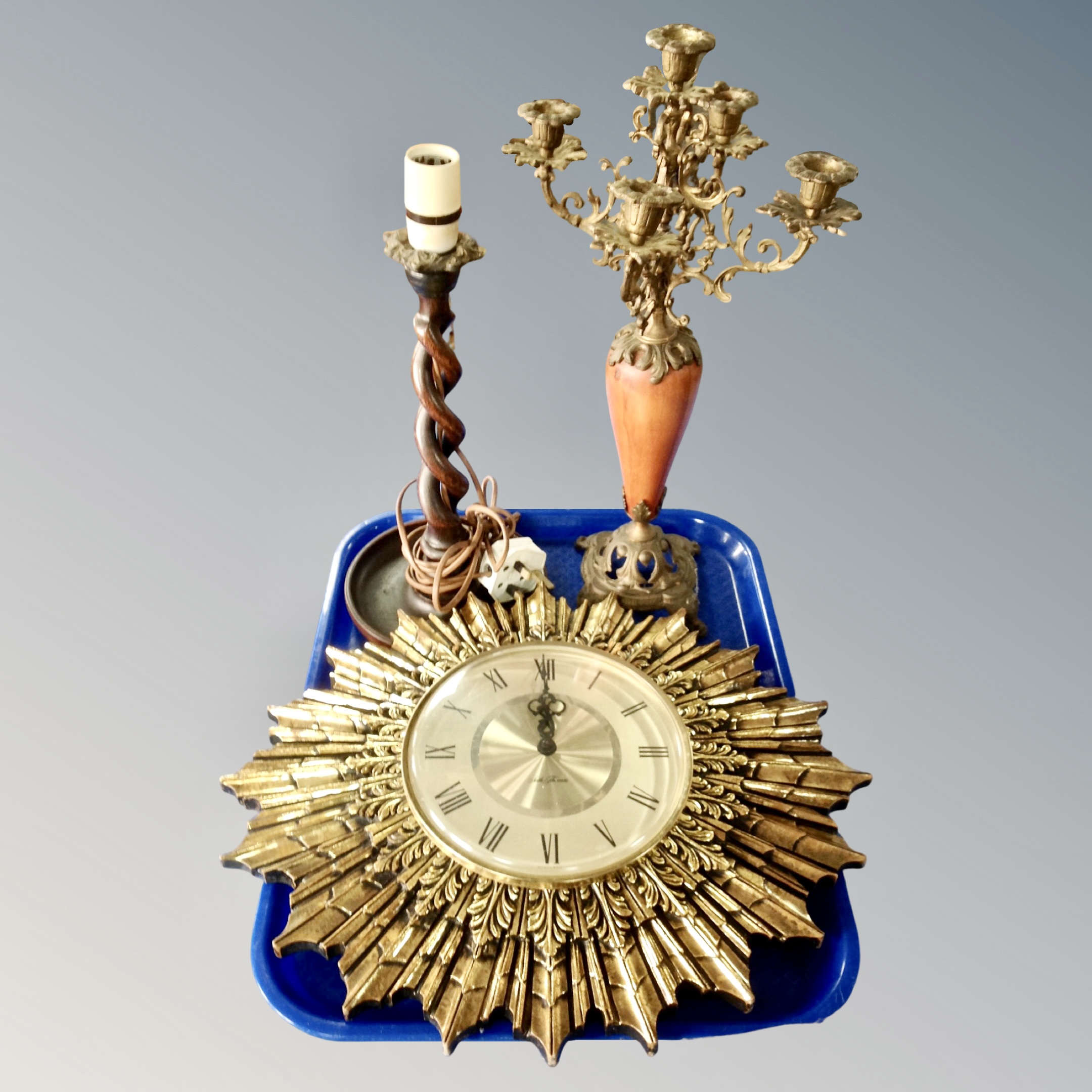 A Seth Thomas Sunburst wall clock with battery movement together with an oak candlestick converted