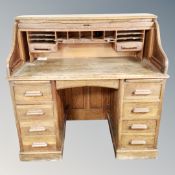 An Edwardian oak roll top desk