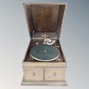 An early 20th century oak cased Chorister table top gramophone.