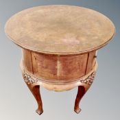 A continental oak and walnut circular occasional table / cabinet on raised legs