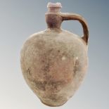 An antique pottery flagon with handle, height 42cm.