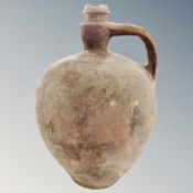 An antique pottery flagon with handle, height 42cm.