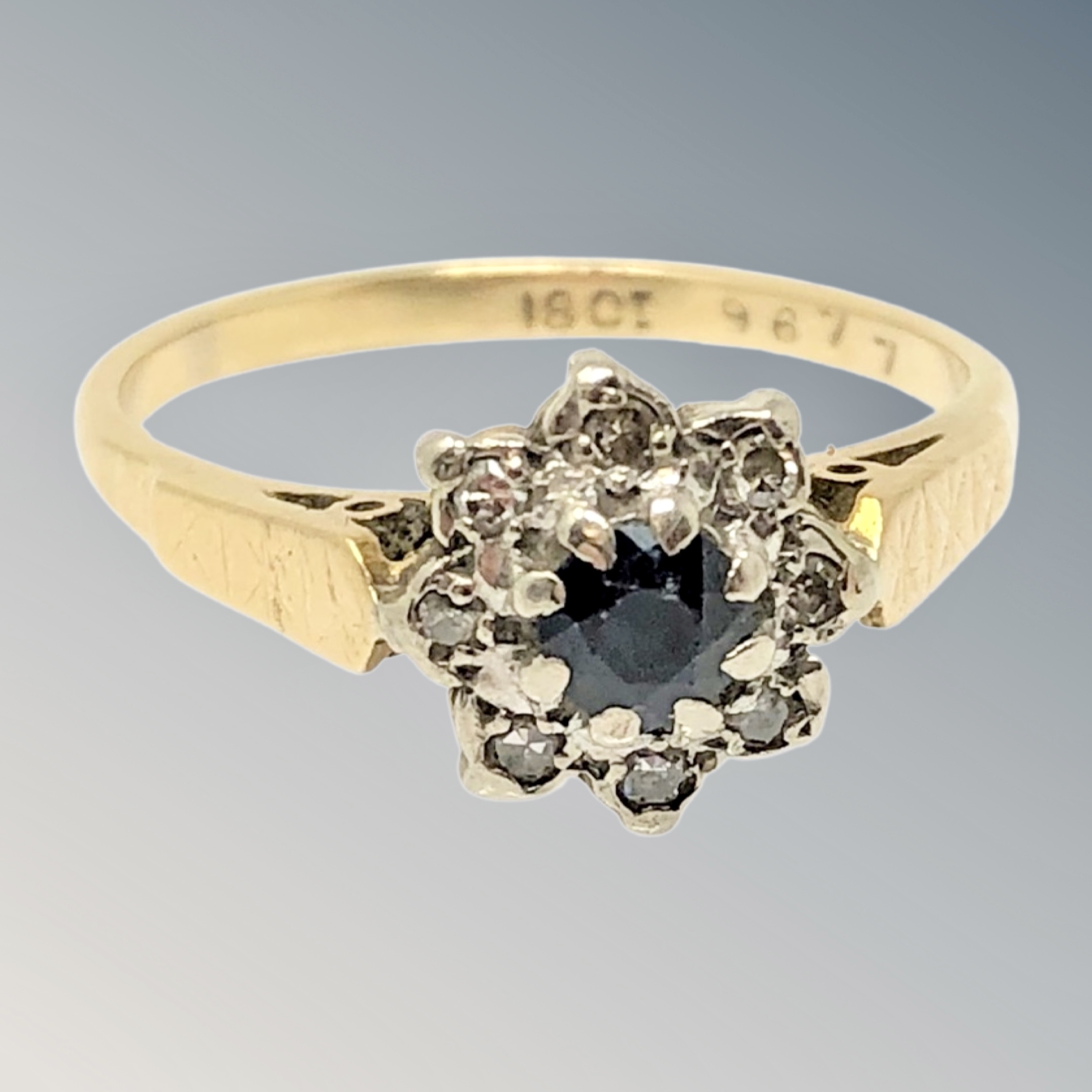 An 18ct gold sapphire and diamond cluster ring, size M CONDITION REPORT: 3.