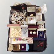 A tray containing costume jewelry, bead necklaces, silver pin, cuff links.