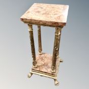 A gilt wood and marble two-tier plant stand on paw feet.