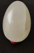 A light jade egg with stand, weight 317g.