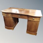 A 19th century mahogany twin pedestal desk fitted three drawers,