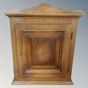 An early 20th century oak panel door wall cabinet,