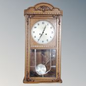A 20th century oak cased eight day wall clock.
