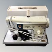 A Singer electric sewing machine in case.
